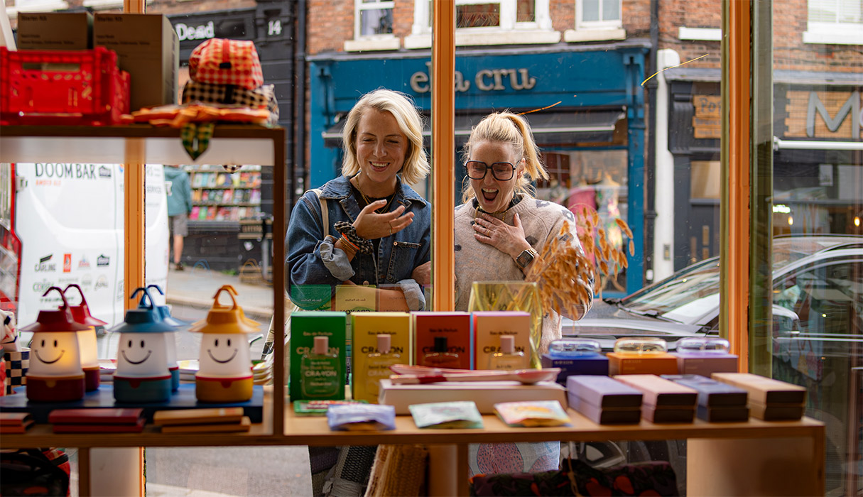 Two women looking into shop with excitement | Visit Shropshire