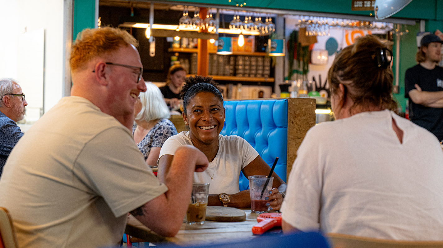 People laughing at a table in a eatery | Visit Shropshire